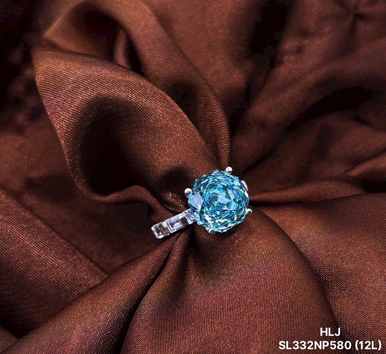 Blue gemstone ring on brown fabric