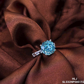 Blue gemstone ring on brown fabric