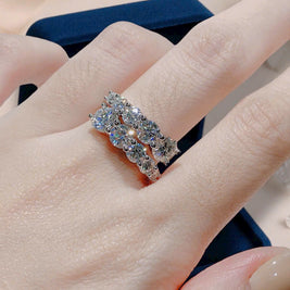 Close-up of a hand wearing a diamond ring with a blurred background
