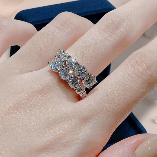 Close-up of a hand wearing a diamond ring with a blurred background