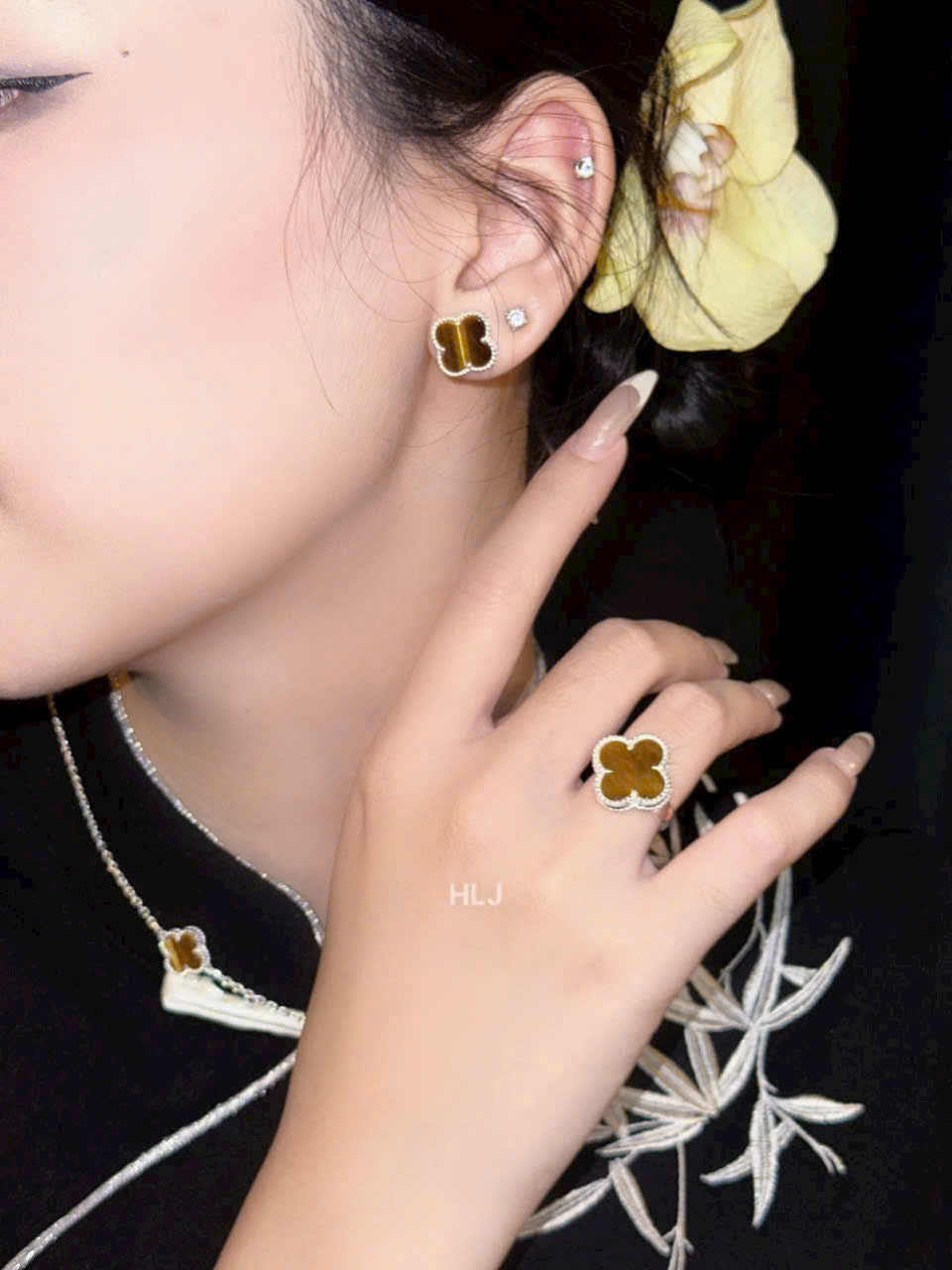 Close-up of a person wearing floral earrings with a blurred background