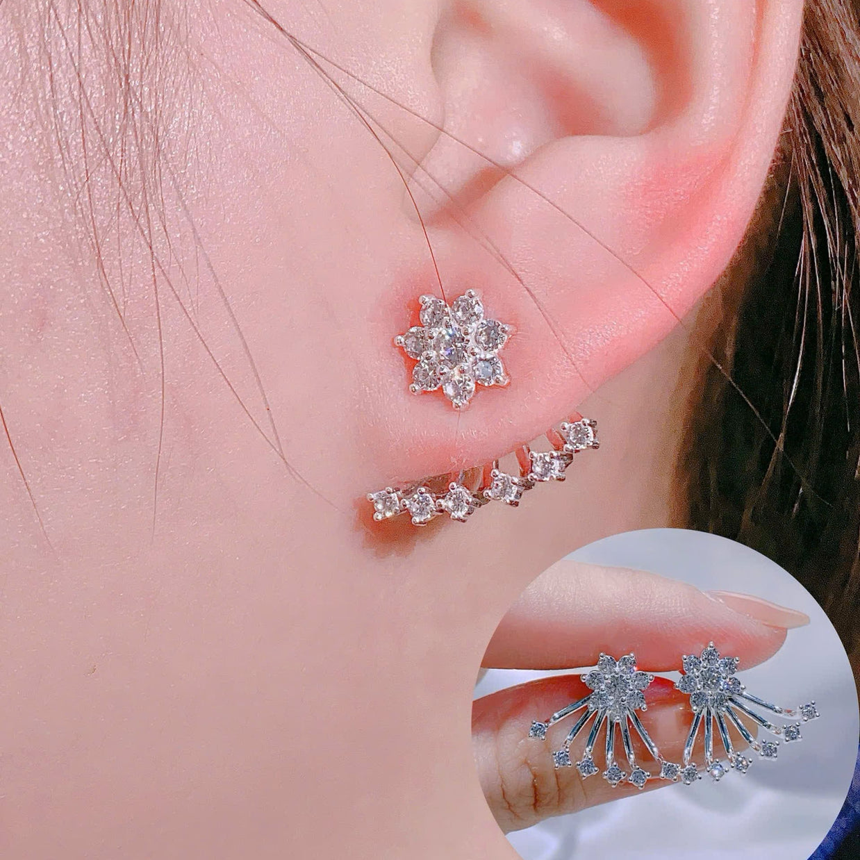 Close-up of a person wearing silver floral earrings with a clear gemstone.