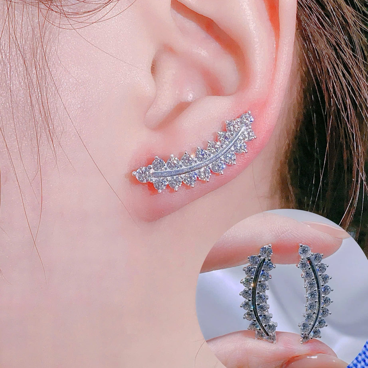 Close-up of an ear wearing a decorative earring with a matching earring held in hand.
