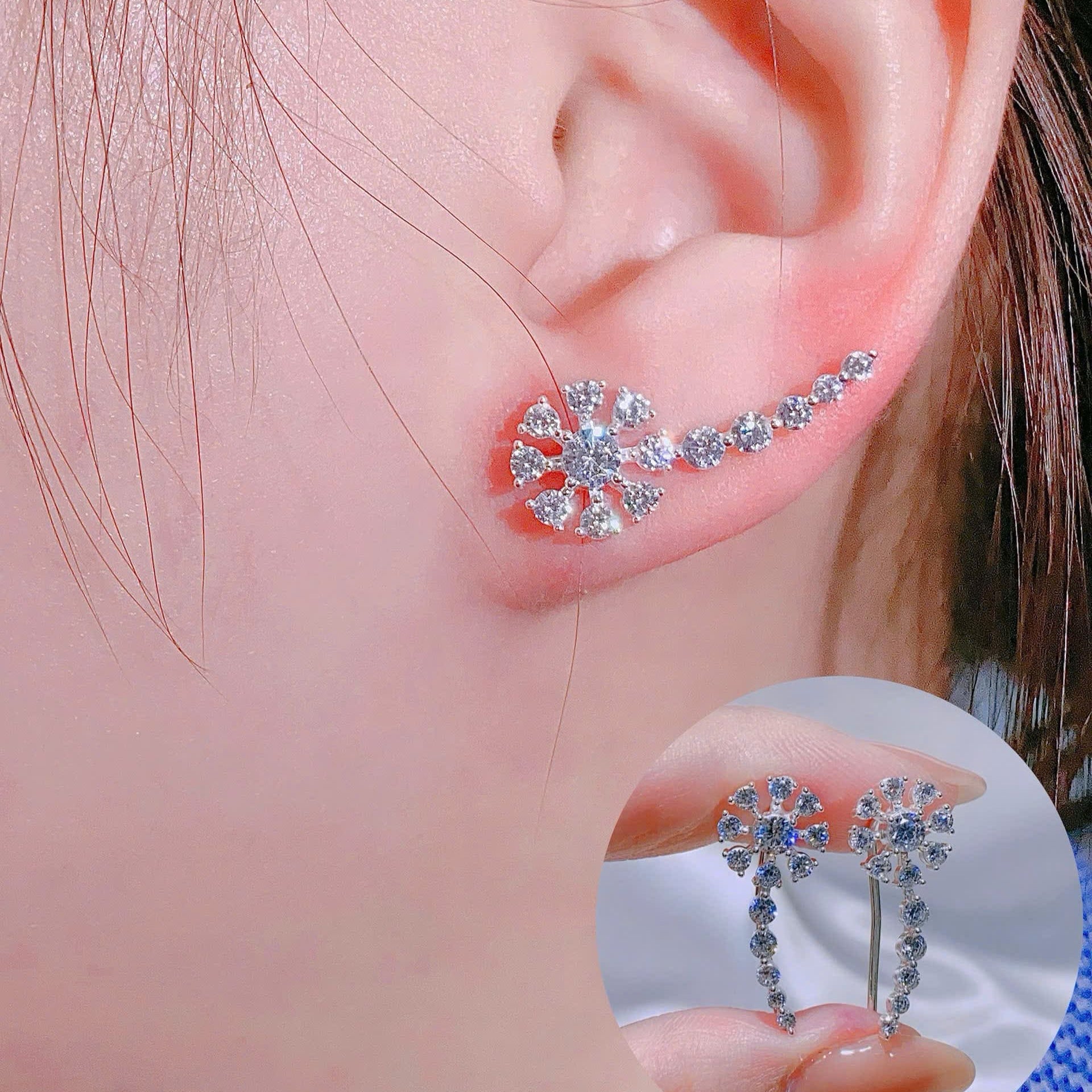 Close-up of an ear wearing a diamond earring with a magnified inset showing the earring details.