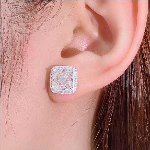 Close-up of an ear wearing a diamond earring with a soft background