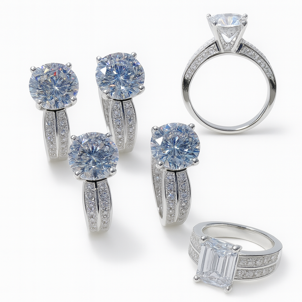 Collection of diamond jewelry including rings and earrings on a white background