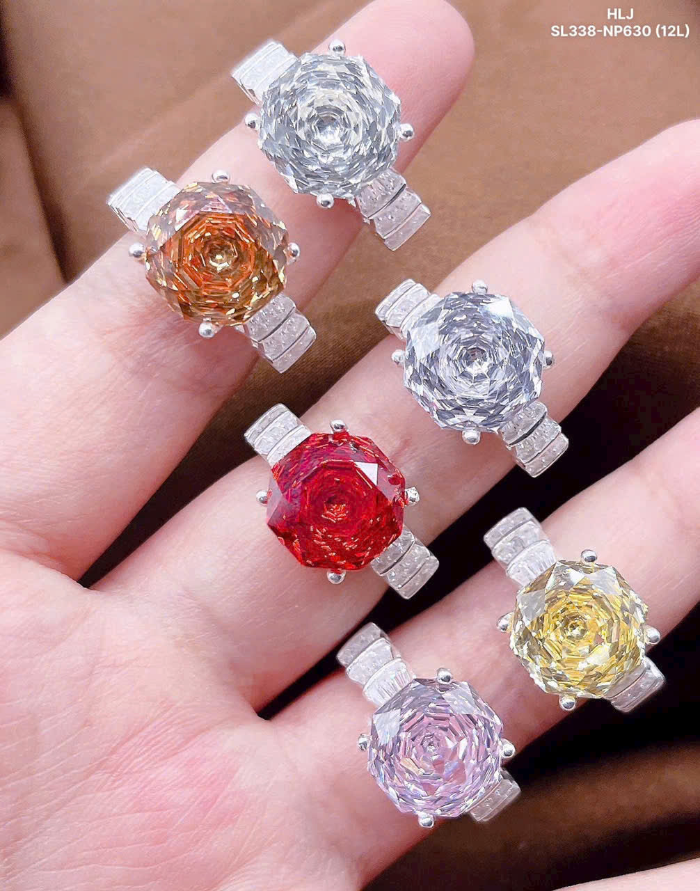 Colorful gemstone pendants on a hand