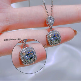 Diamond necklace held by a hand with close-up inset, brand 'HLJ' visible