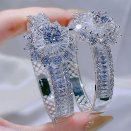 Diamond  bracelet held by a hand with a blurred background