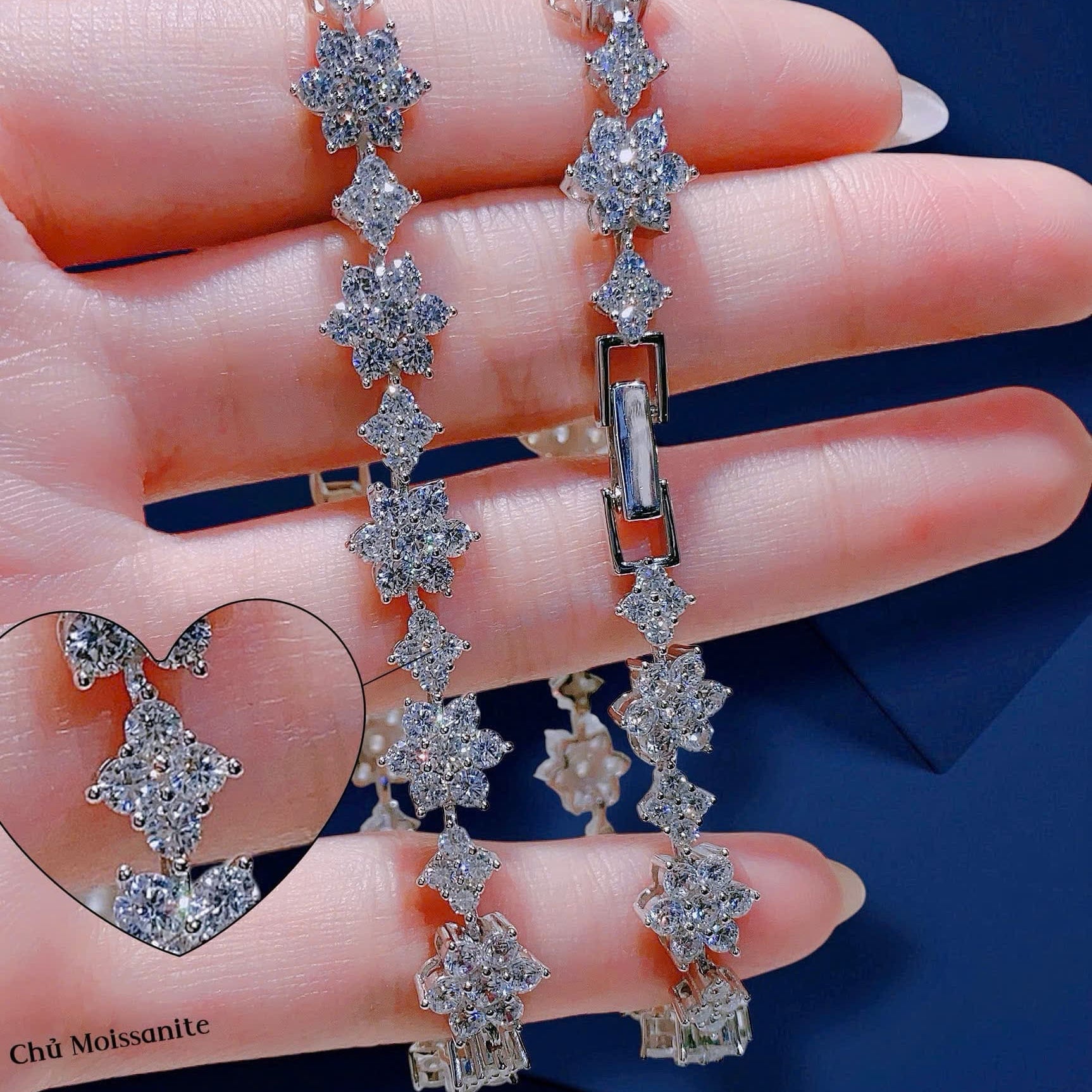 Diamond bracelet held on a hand with a blue background