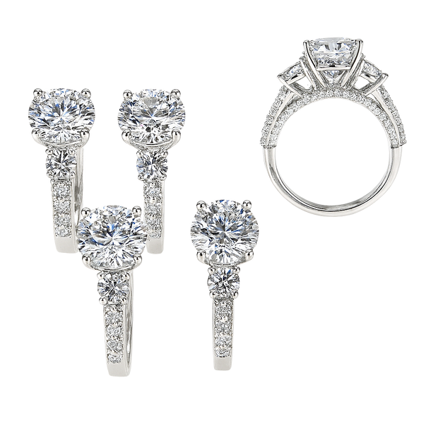 Diamond jewelry set including ring, earrings, and brooch on a white background