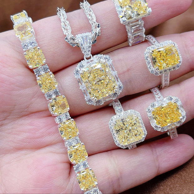Diamond jewelry set with yellow gemstones on a hand