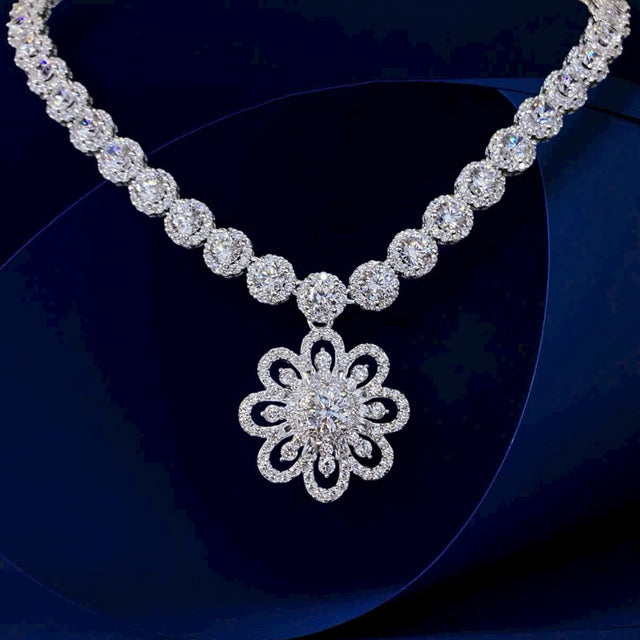 Diamond necklace with a floral pendant on a dark background