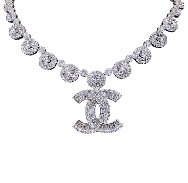 Diamond necklace with a prominent 'CC' logo on a white background