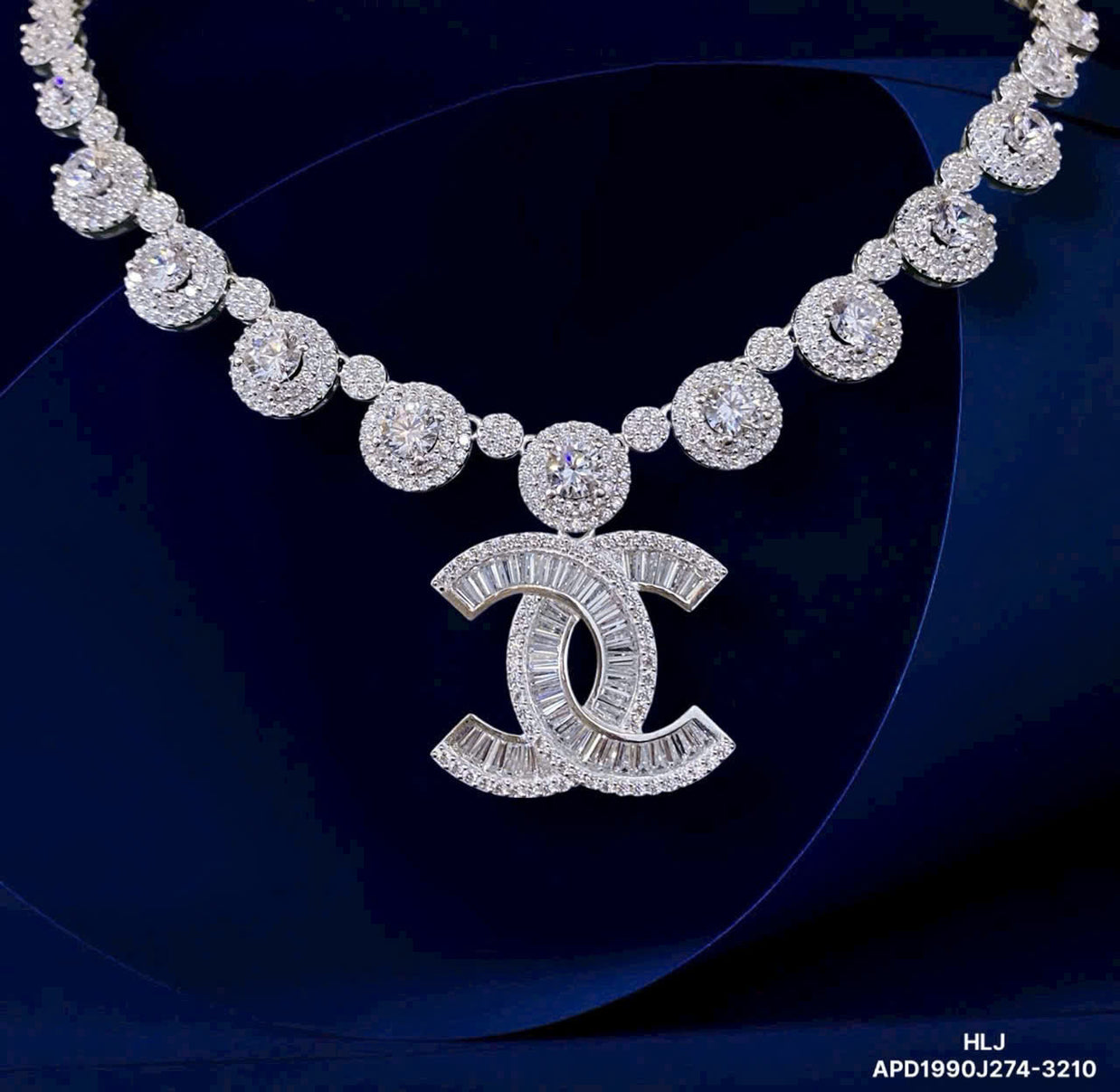 Diamond necklace with a prominent logo on a dark background
