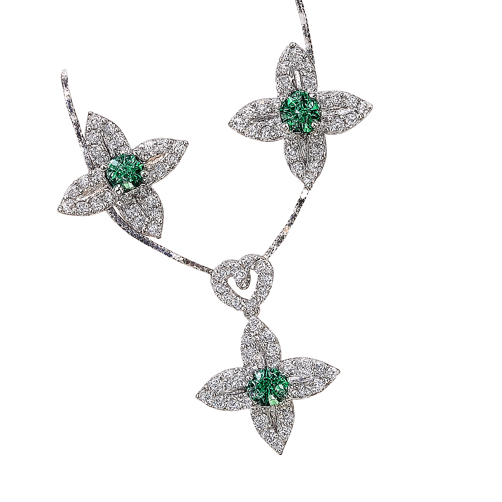 Diamond necklace with emerald stones on a white background