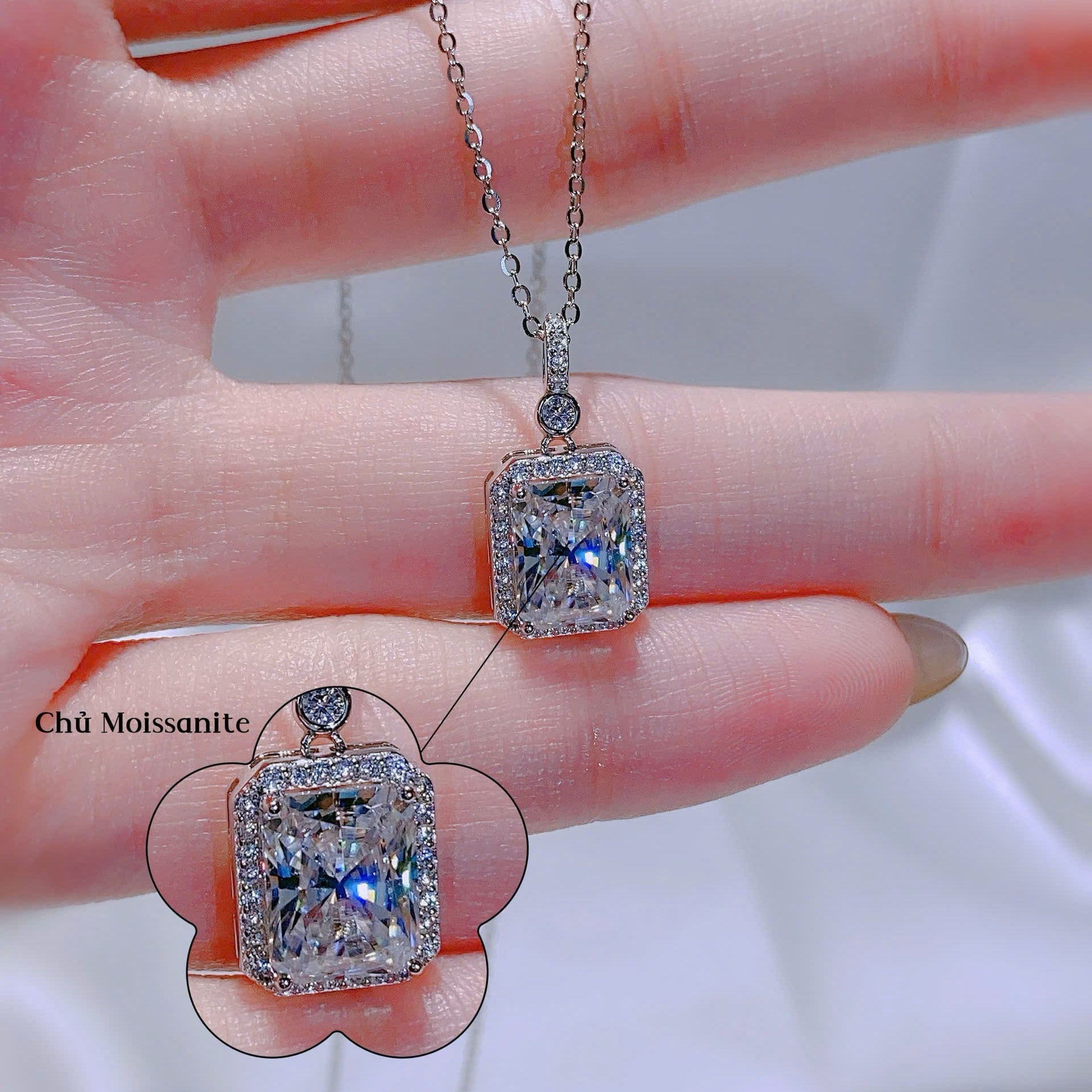 Diamond pendants on a hand with a blurred background