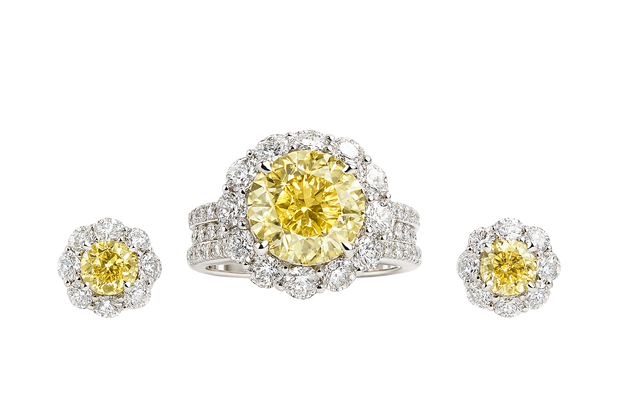 Diamond ring and earrings with yellow gemstones on a white background

