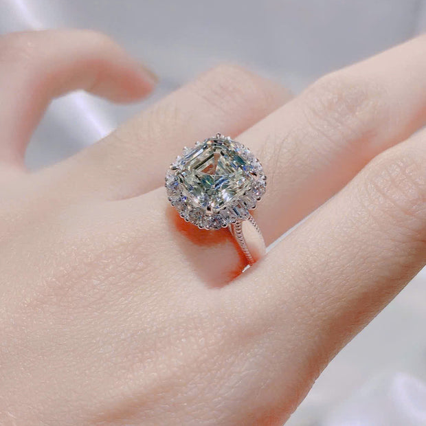 Diamond ring on a finger with a blurred background