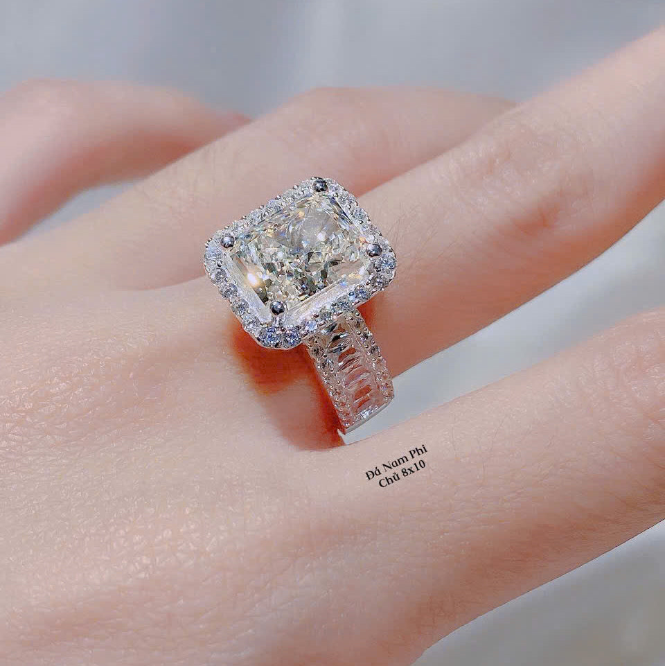 Diamond ring on a finger with a blurred background