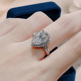 Diamond ring on a finger with a blurred background