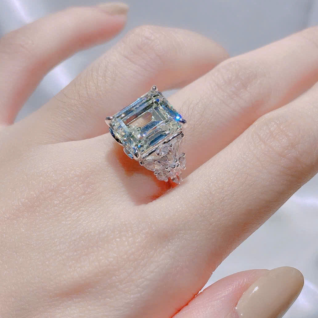 Diamond ring on a finger with a blurred background