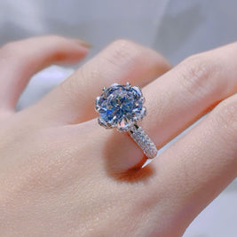 Diamond ring on a finger with a blurred background