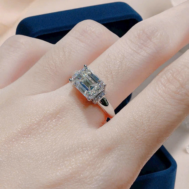 Diamond ring on a hand with a neutral background