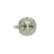 Diamond ring with a square-cut center stone on a white background