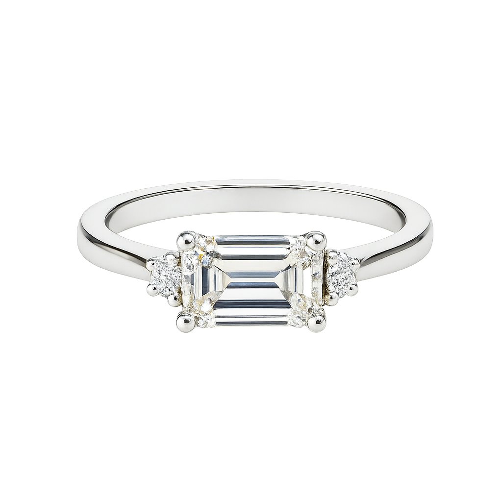 Diamond ring with emerald-cut center stone and smaller side stones on a white background