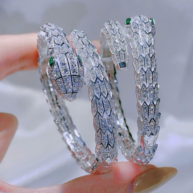 Diamond snake-shaped bracelet on a hand with a blurred background