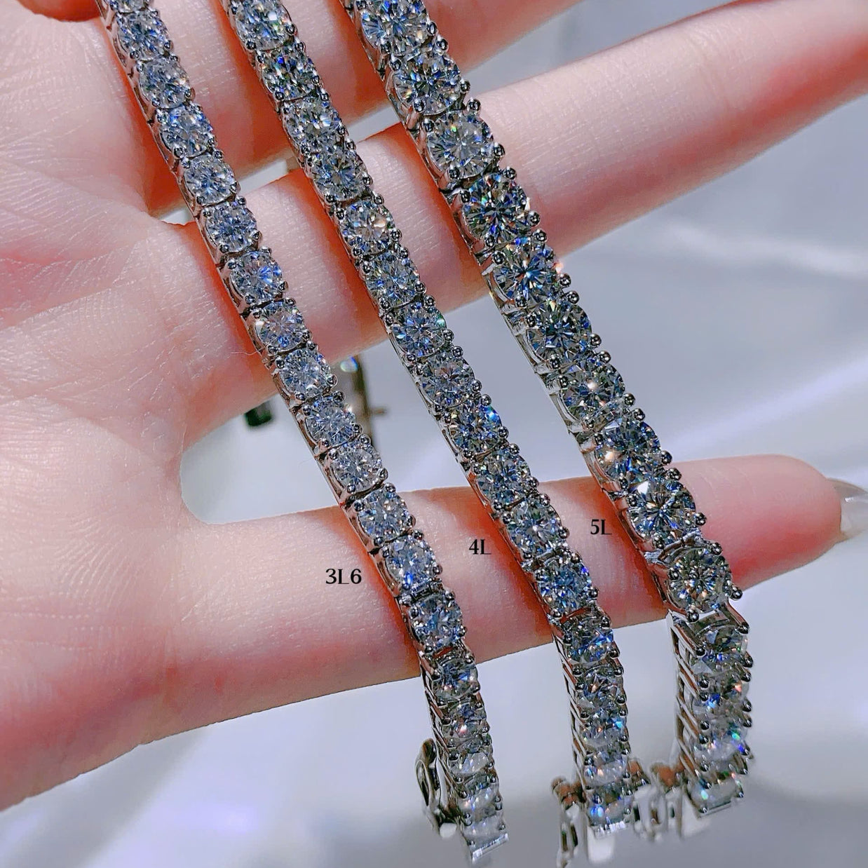 Diamond tennis bracelet on a hand with measurement scale