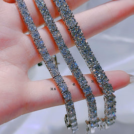 Diamond tennis bracelet on a hand with measurement scale