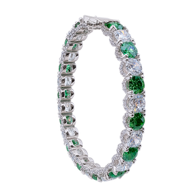 Elegant bracelet with green gemstones and clear stones on a white background