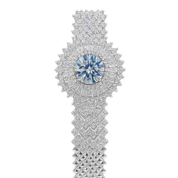 Elegant diamond bracelet with a central blue gemstone on a white background