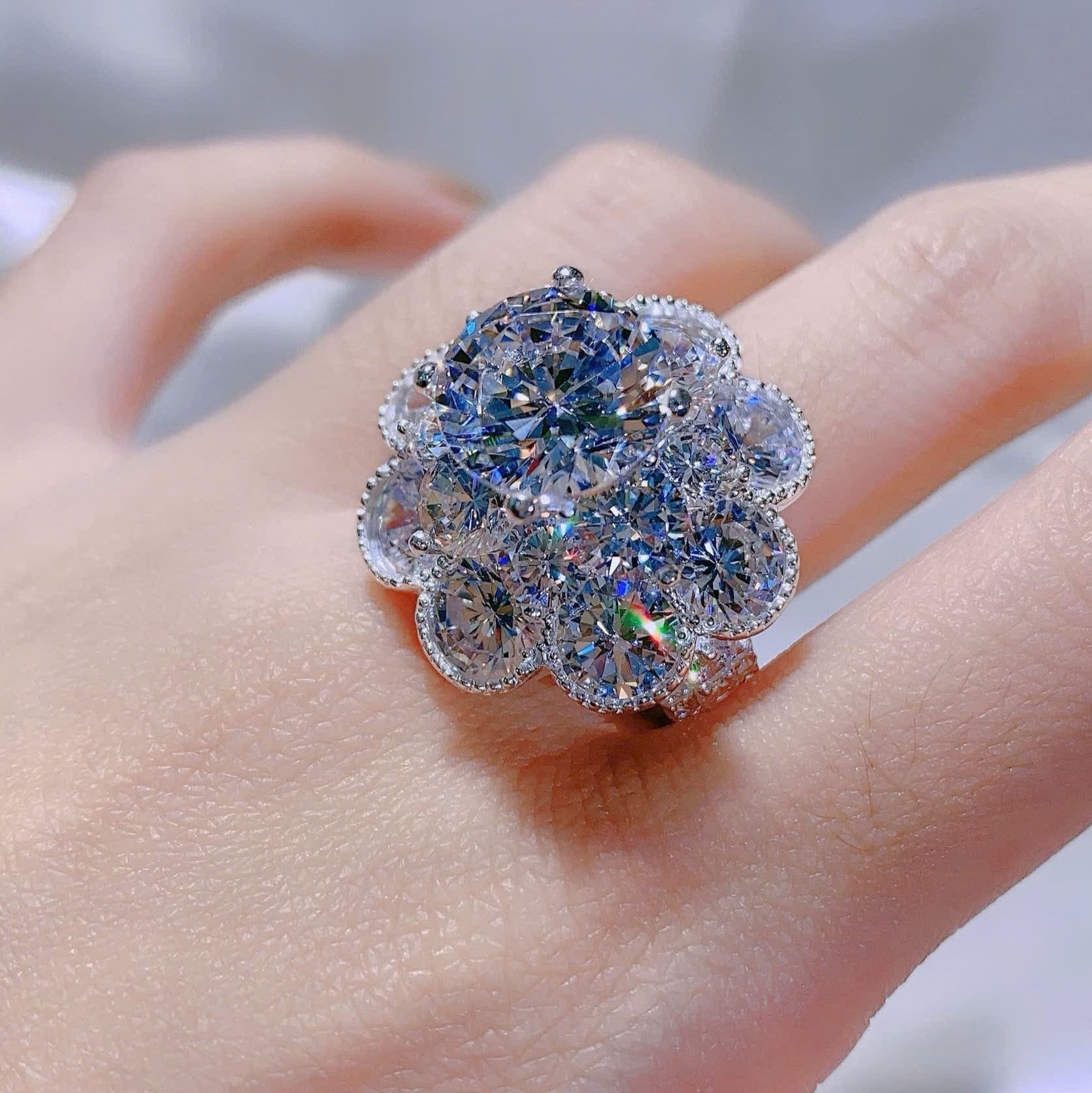 Elegant diamond ring on a finger with a blurred background