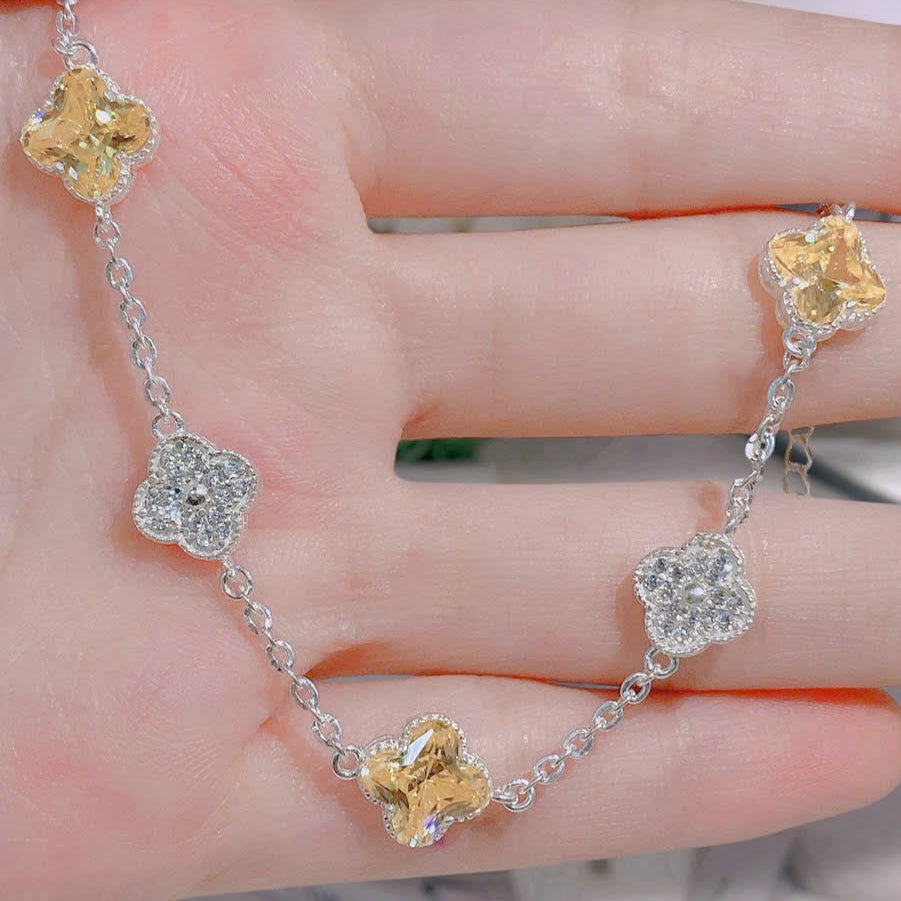 Gold and silver bracelet on a hand with a blurred background