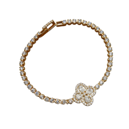 Gold bracelet with diamond accents on a white background