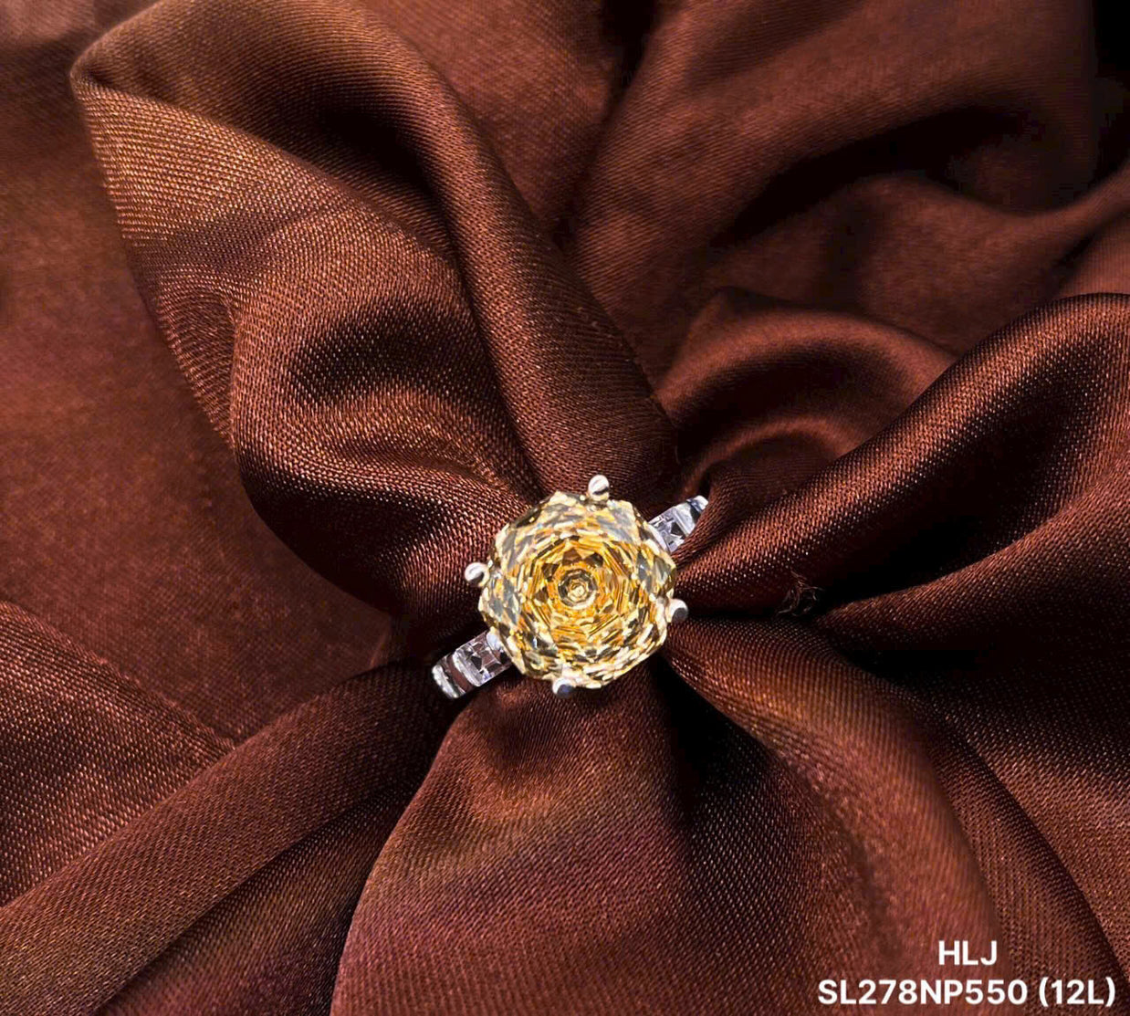 Gold ring with a floral design on brown fabric