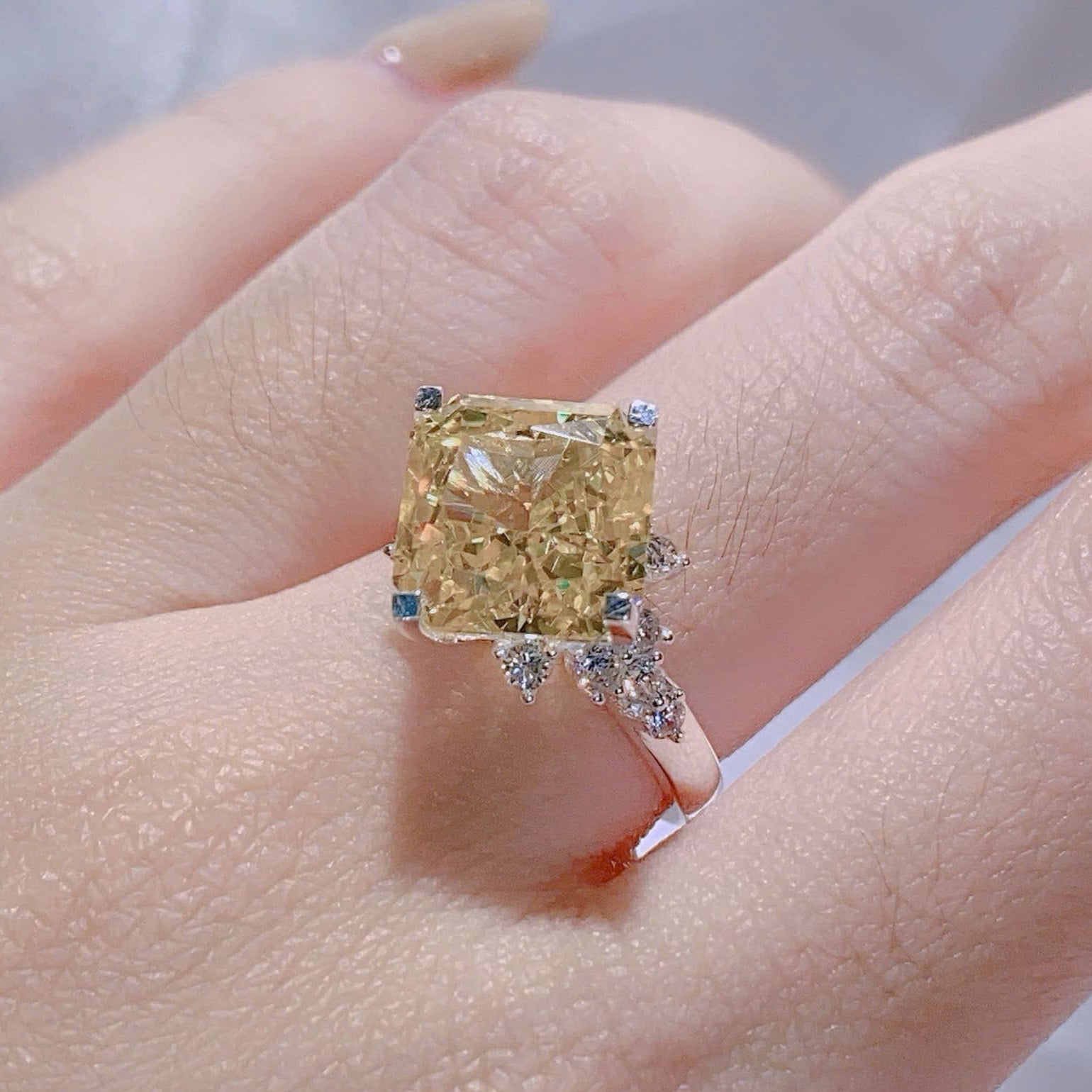 Gold ring with a large diamond on a hand