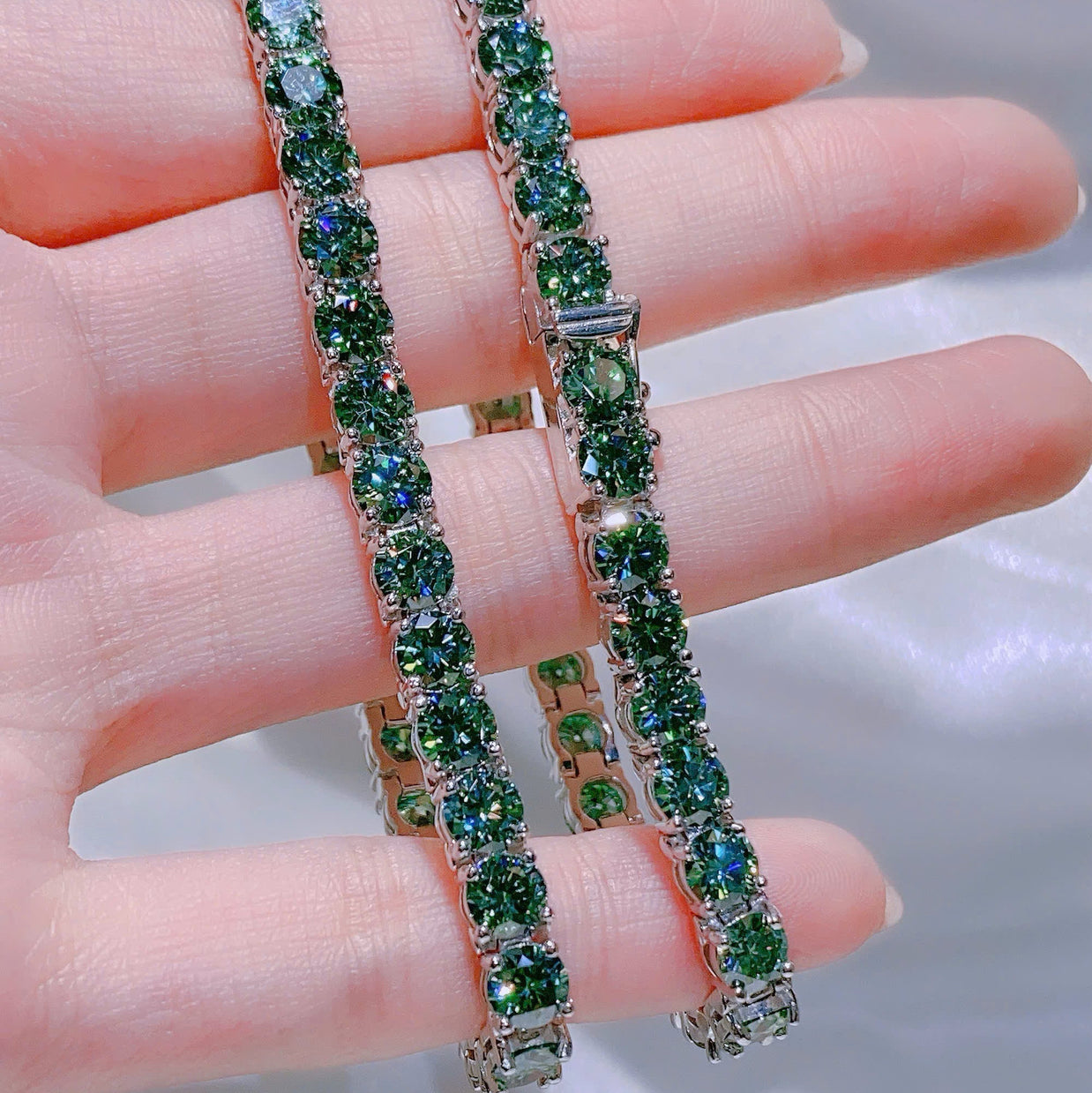 Green gemstone bracelet on a hand with a blurred background