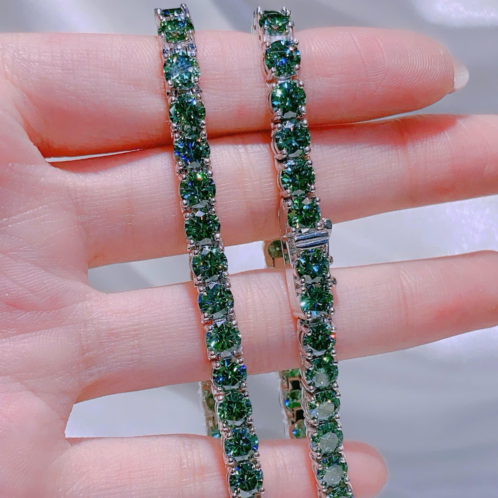 Green gemstone bracelet on a hand with a blurred background