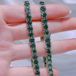 Green gemstone bracelet on a hand with a blurred background