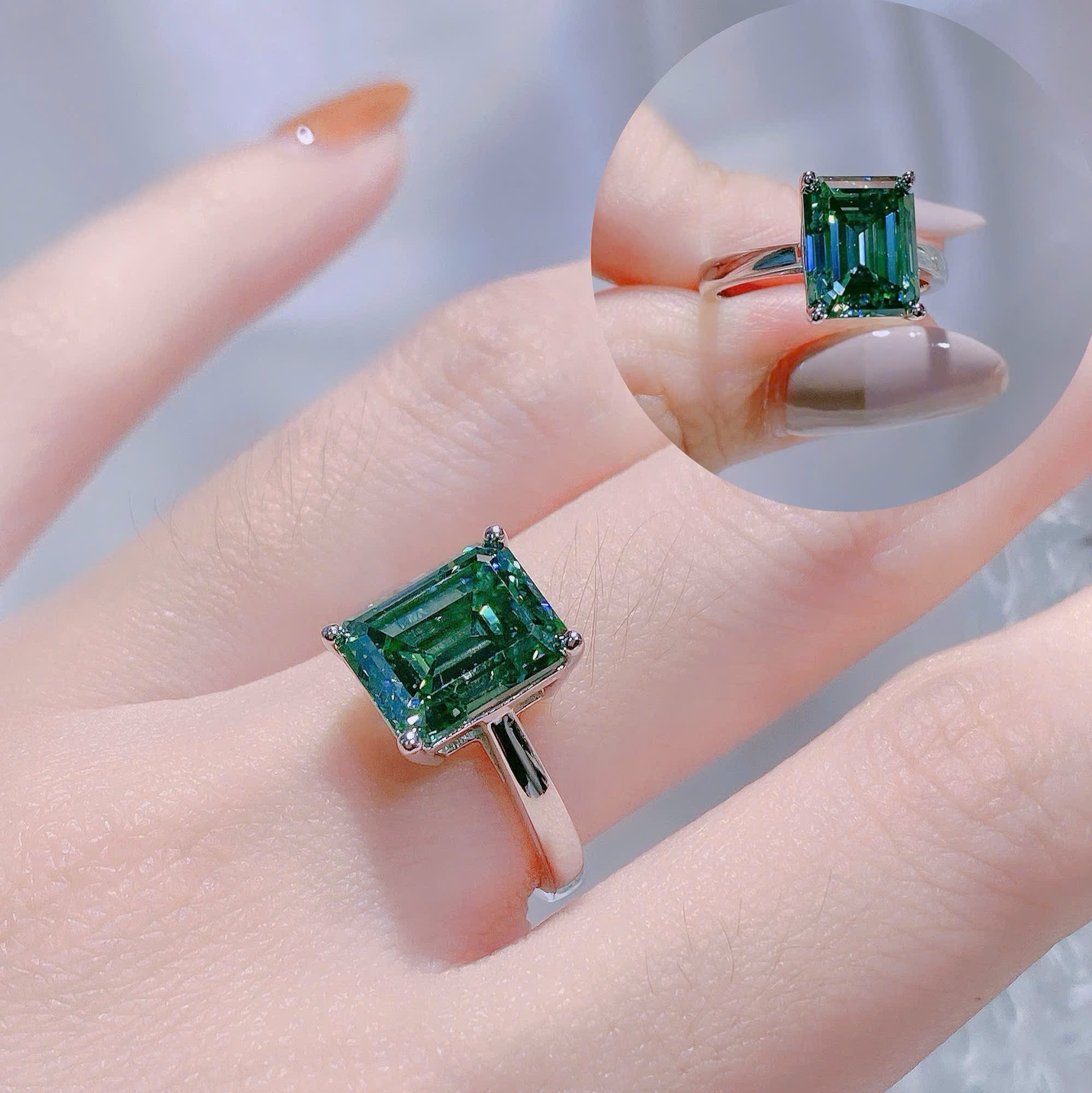 Green gemstone ring on a hand with a blurred background