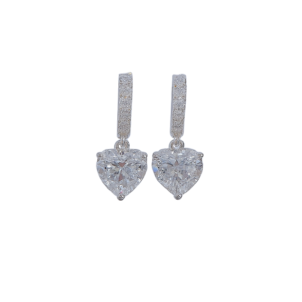 Heart-shaped diamond earrings on a white background