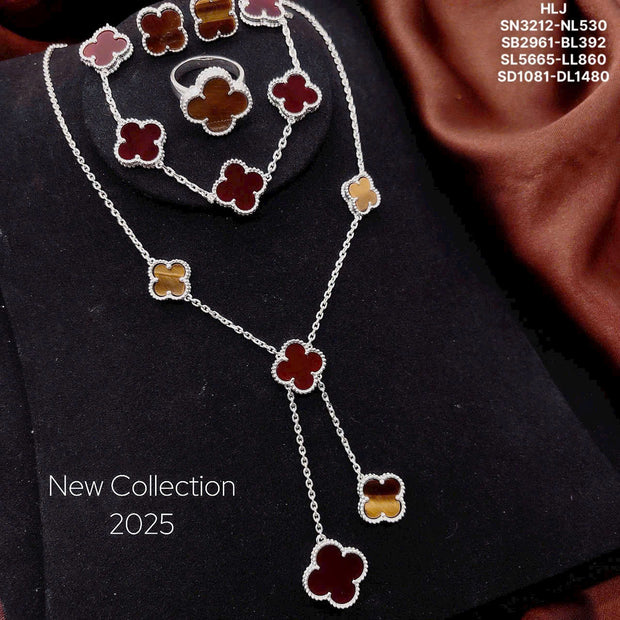 Jewelry set with floral designs on a dark fabric background, labeled 'New Collection 2025'.