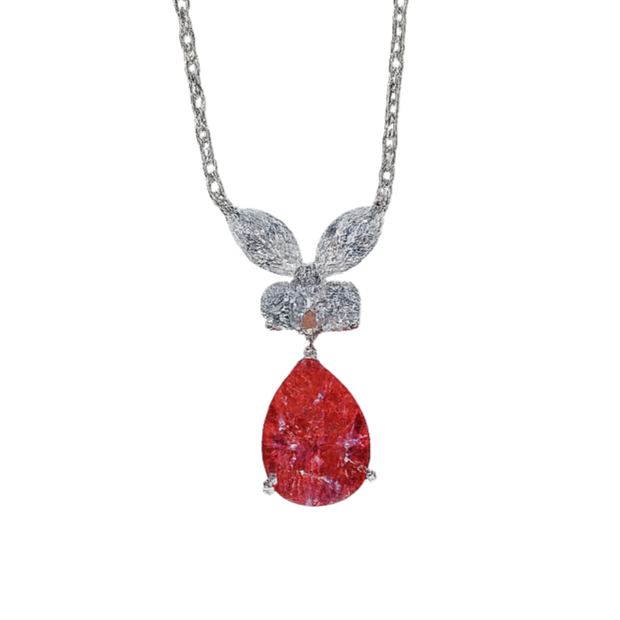 Necklace with a red teardrop pendant and silver chain on a white background