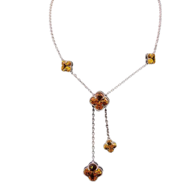Necklace with floral pendant and amber-colored stones on a white background