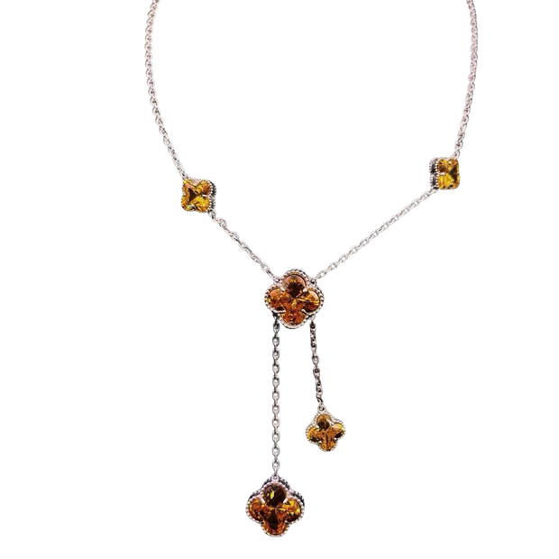 Necklace with floral pendant and amber-colored stones on a white background