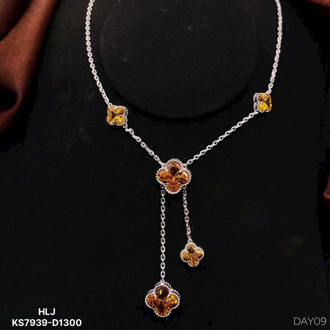 Necklace with floral pendants on a black background